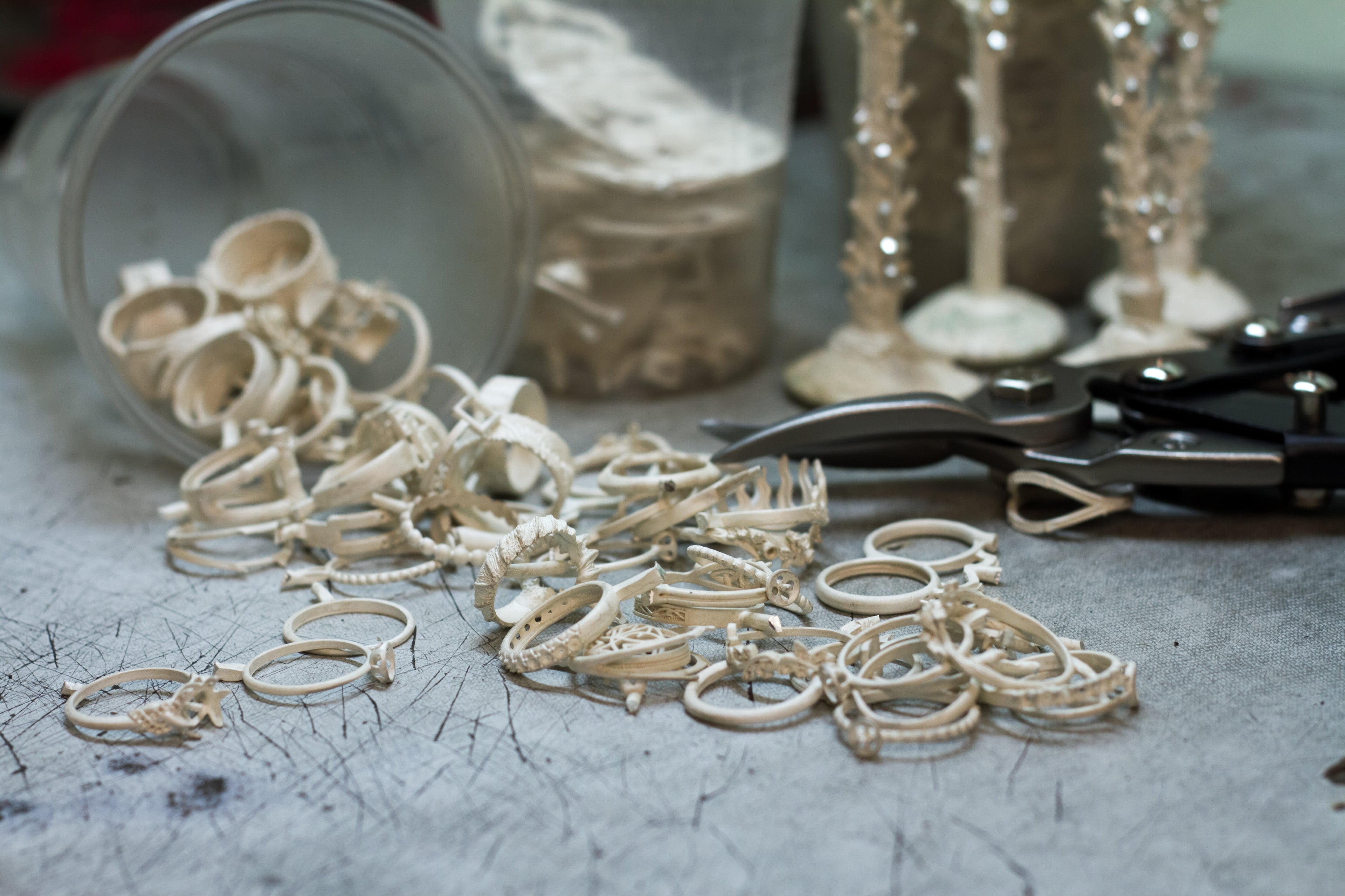 Assorted handcrafted rings and tools in an artisan jewellery studio, showcasing the intricate process behind each Salvessa piece