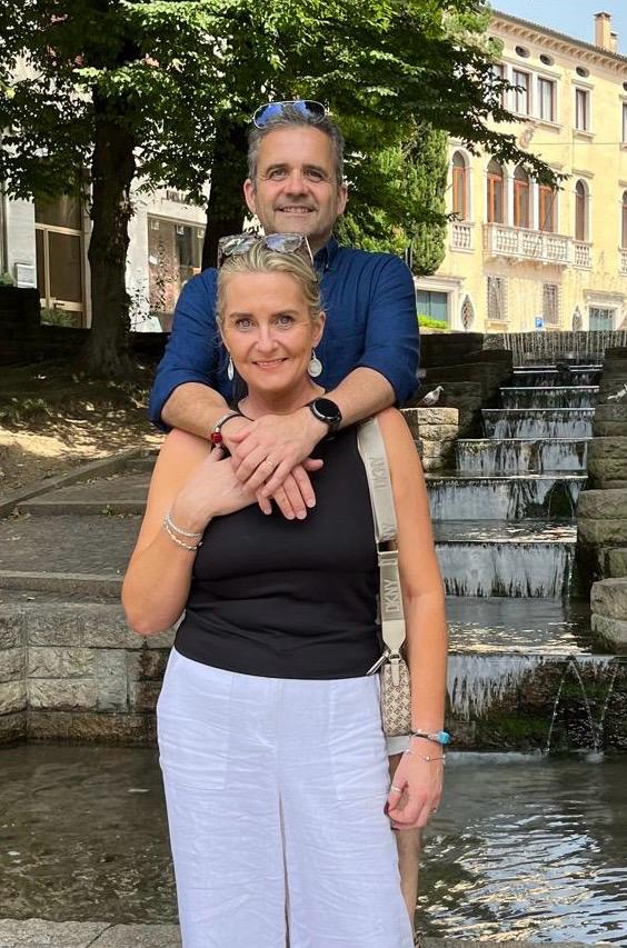 Lisa and Roby, founders of Salvessa, standing together in Treviso,Italy, on holiday, sharing their passion for sustainable style and artisan jewellery.